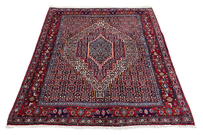 Flat carpet with a square medallion, red patterned field, and wide border