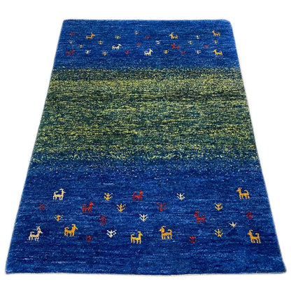 Gabbeh rug with blue-green color gradients and small animal motifs