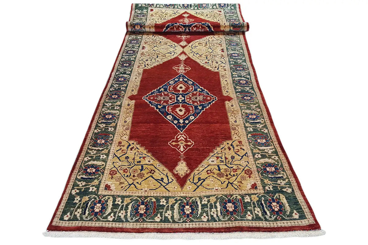 Oriental rug lying flat with a red central area and blue ornamental borders