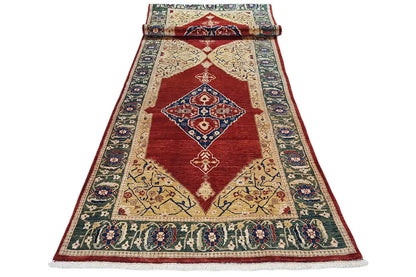Oriental rug lying flat with a red central area and blue ornamental borders