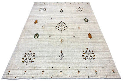 Light beige rug with a central star-floral pattern and small surrounding ornaments