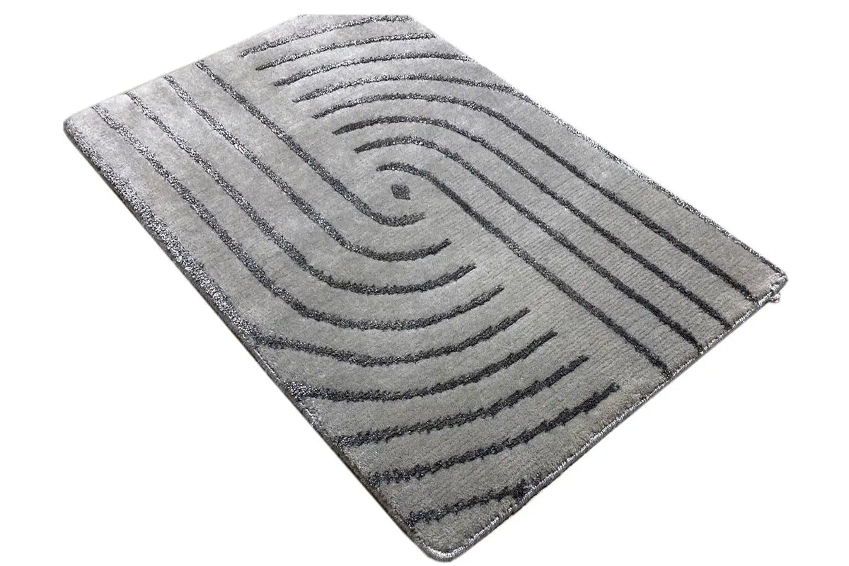 Rectangular rug with a gray base and an angled curved-line pattern