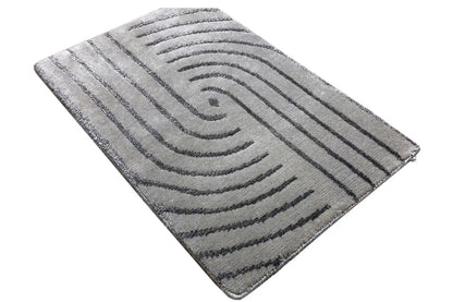 Rectangular rug with a gray base and an angled curved-line pattern
