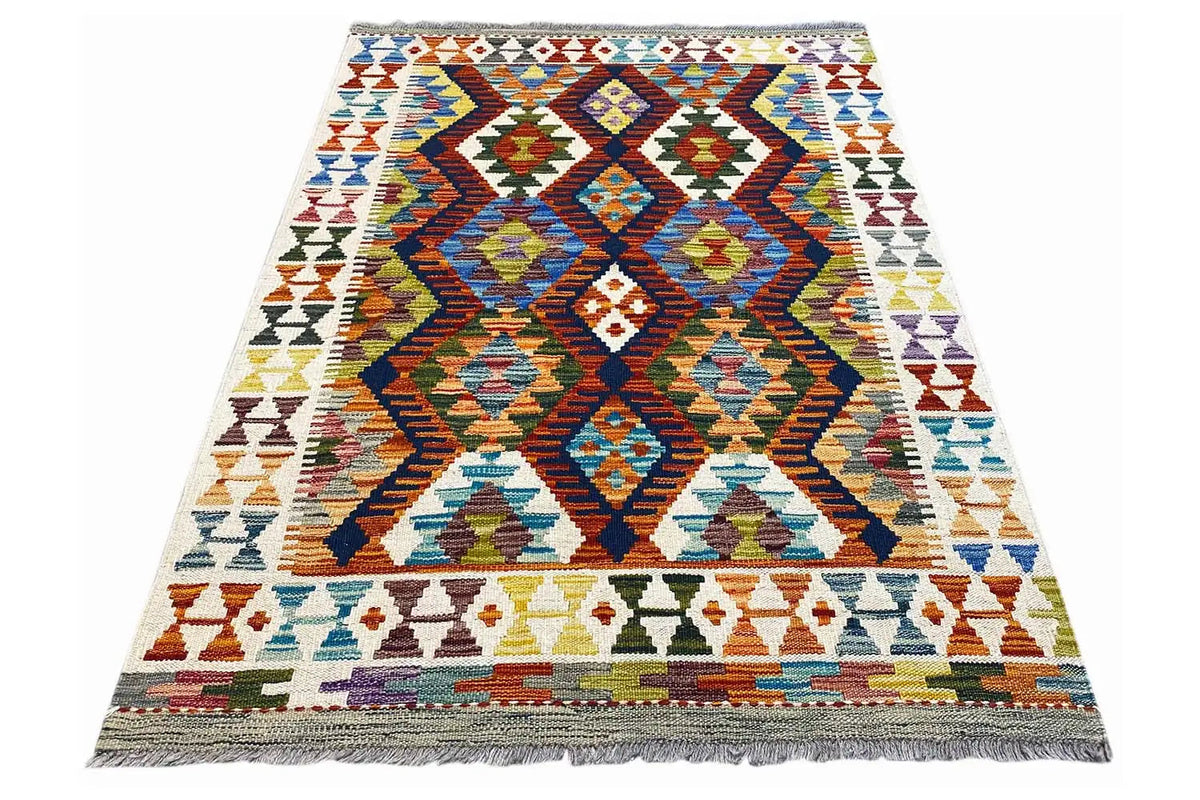 Rectangular kilim rug with a central diamond motif and colorful borders, fringes