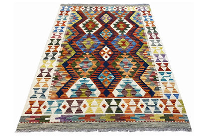 Rectangular kilim rug with a central diamond motif and colorful borders, fringes
