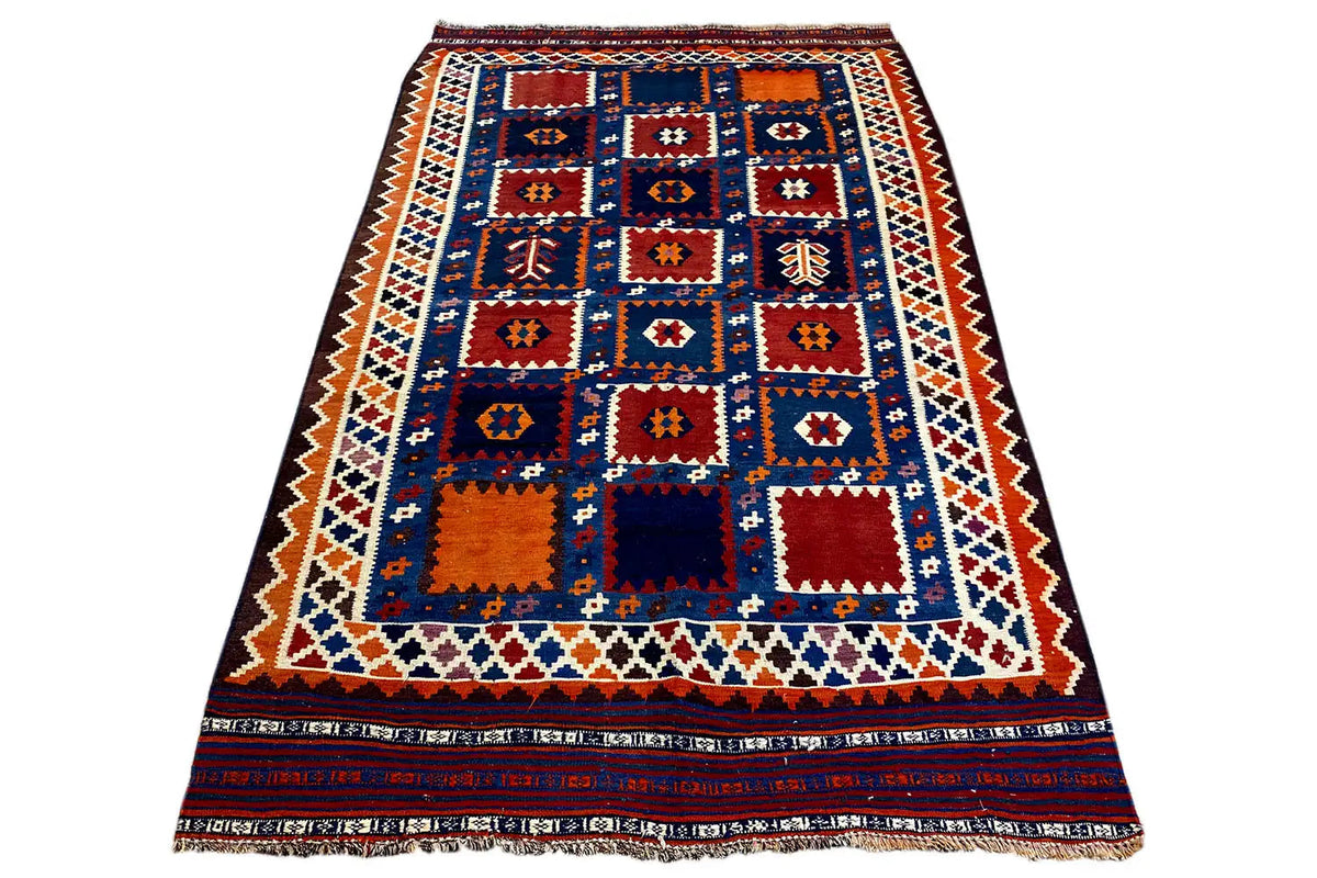 Kilim rug with a central diamond field in blue, red, orange, and white, with a wide border.