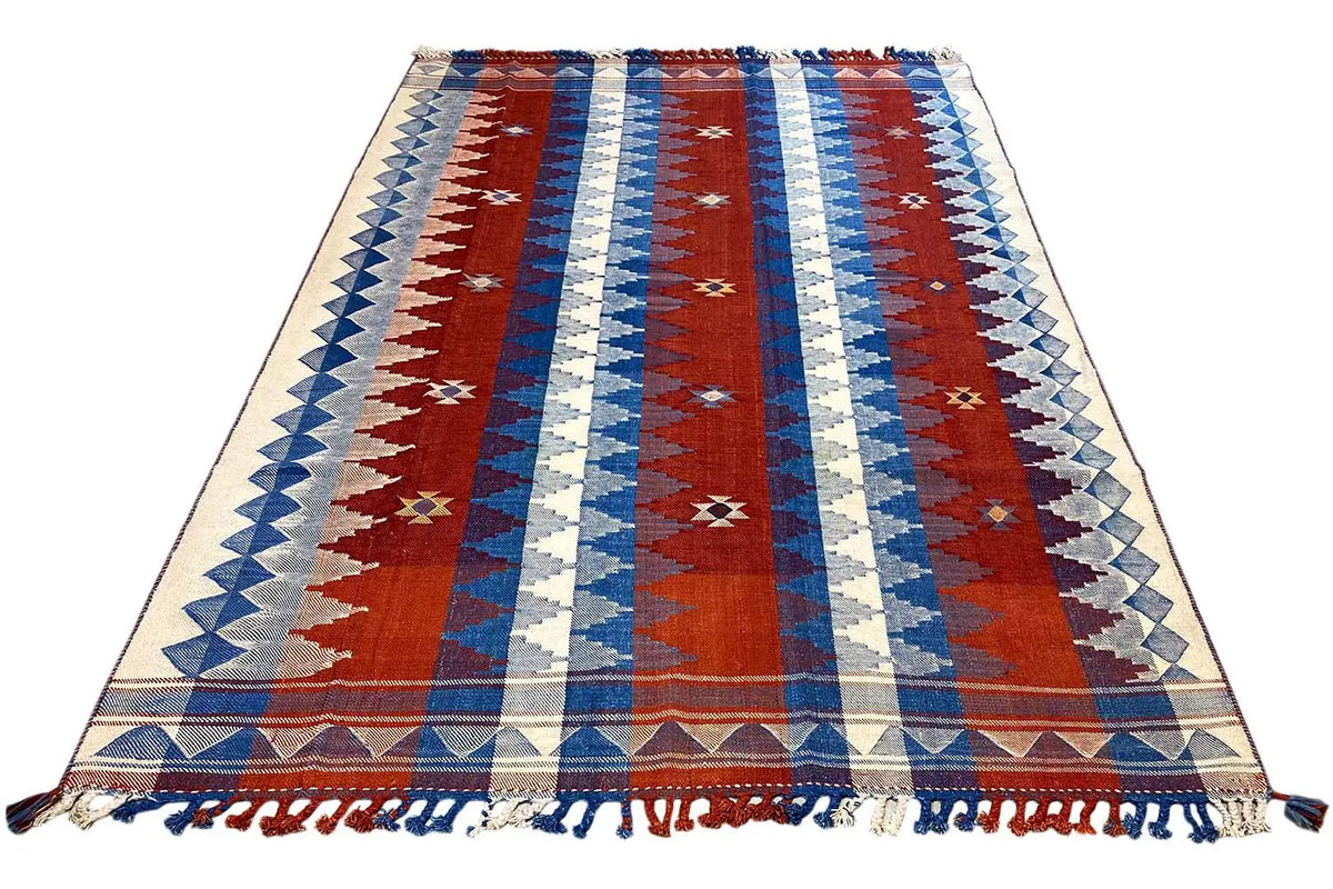 Rug with red center stripes, blue and cream sections, border, and fringe