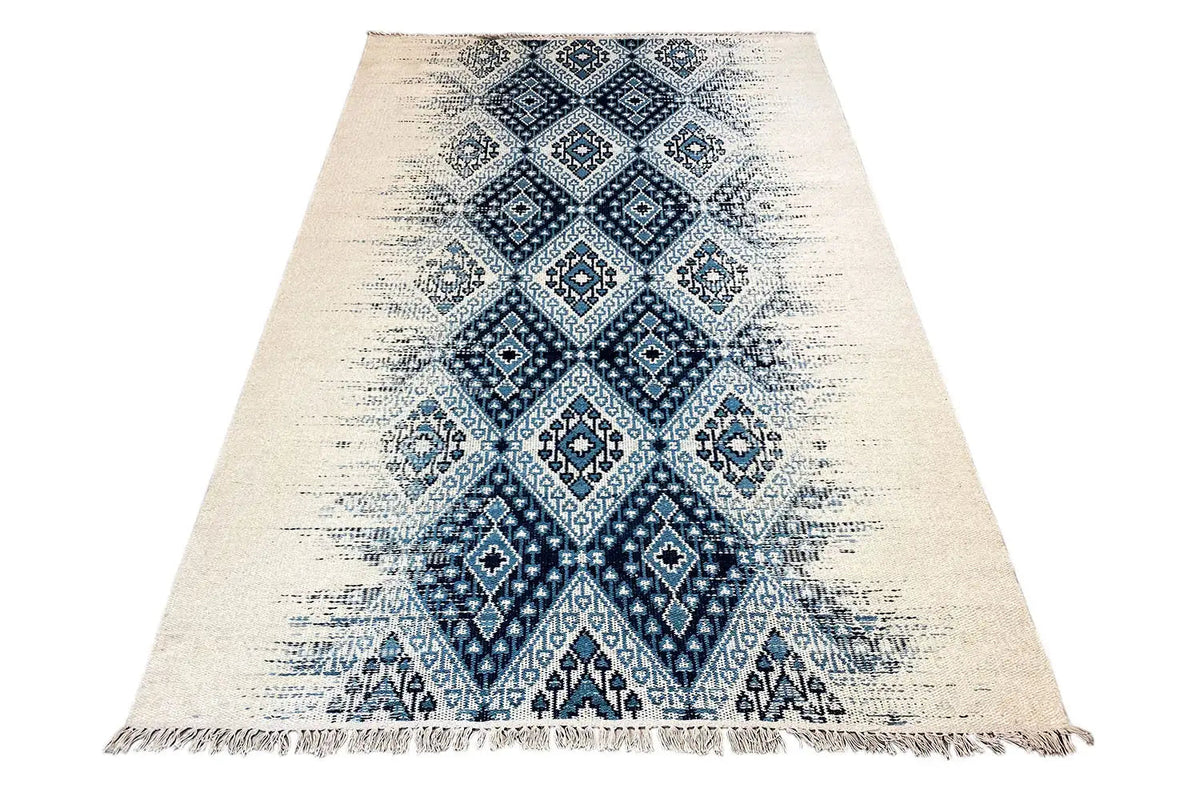 Kelim dhurrie rug, appearing triangular in shape, blue pattern in the center, with fringes