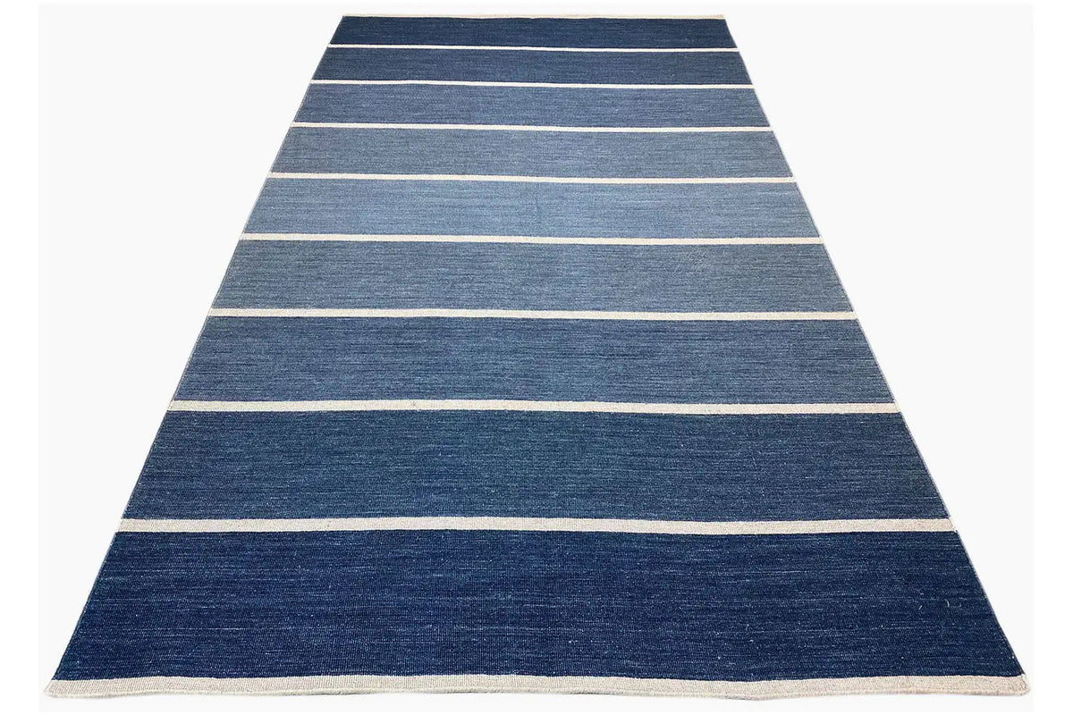 Rug in triangular view, dark blue with beige horizontal stripes
