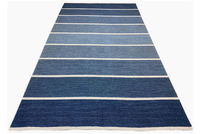 Rug in triangular view, dark blue with beige horizontal stripes