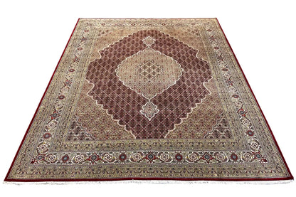 Brown rug with a central medallion, framed by decorative borders