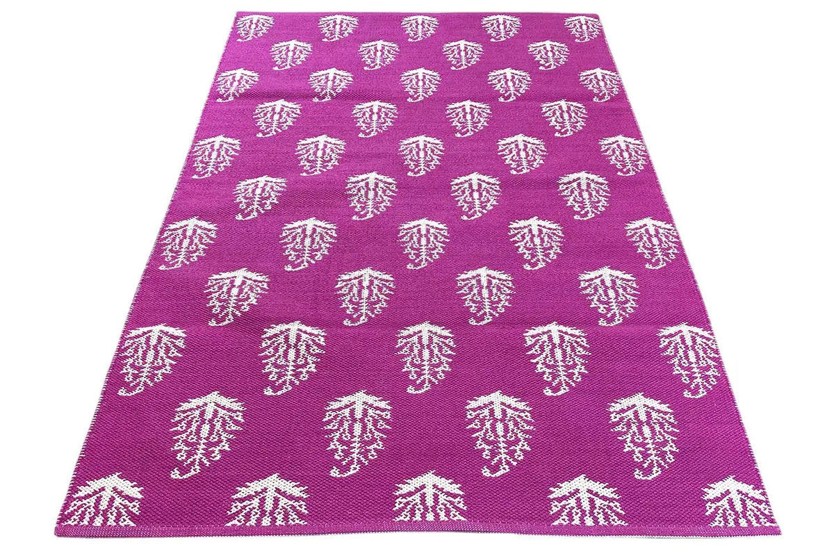 Modern kilim with a purple background and white tree ornaments, smoothly folded