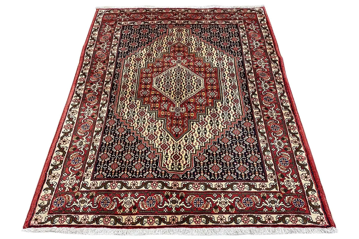 Rectangular rug with a red border, a light central medallion, and a diamond pattern