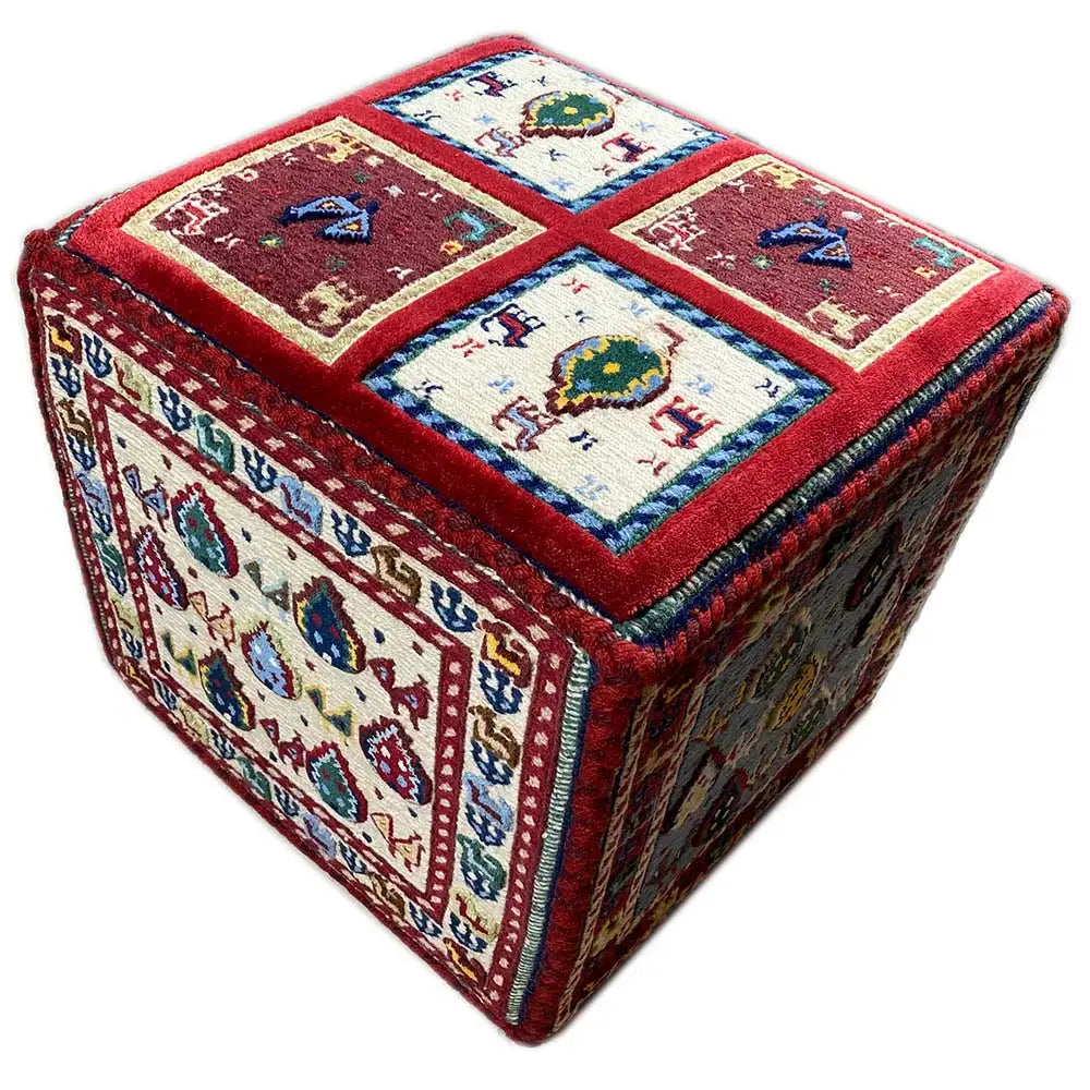Soumak rug cube with blue borders and colorful red ornamental motifs.
