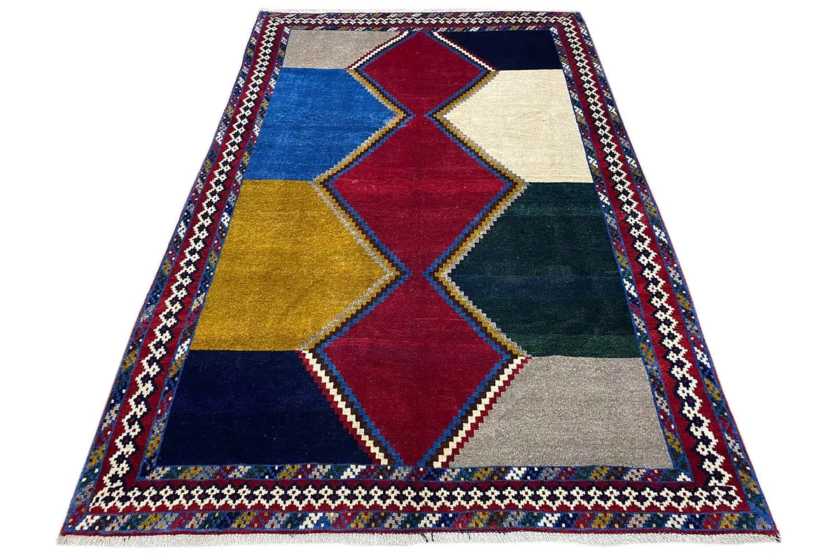 Flat-weave rug with diamond patterns and a contrasting border in red and blue