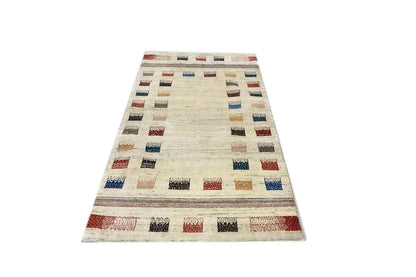 Beige Gabbeh rug with a large central section and multicolored grid squares