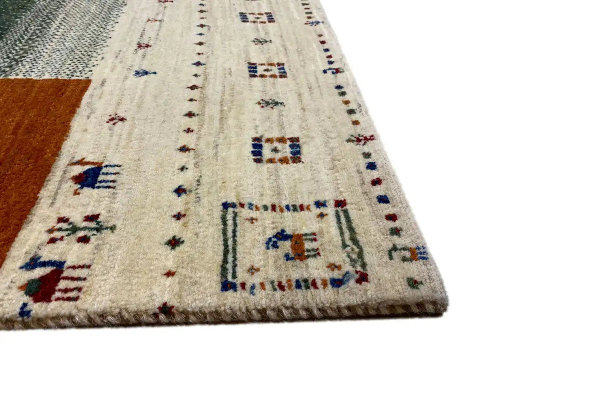 Close-up: Gabbeh rug with embroidered border pattern and blue square
