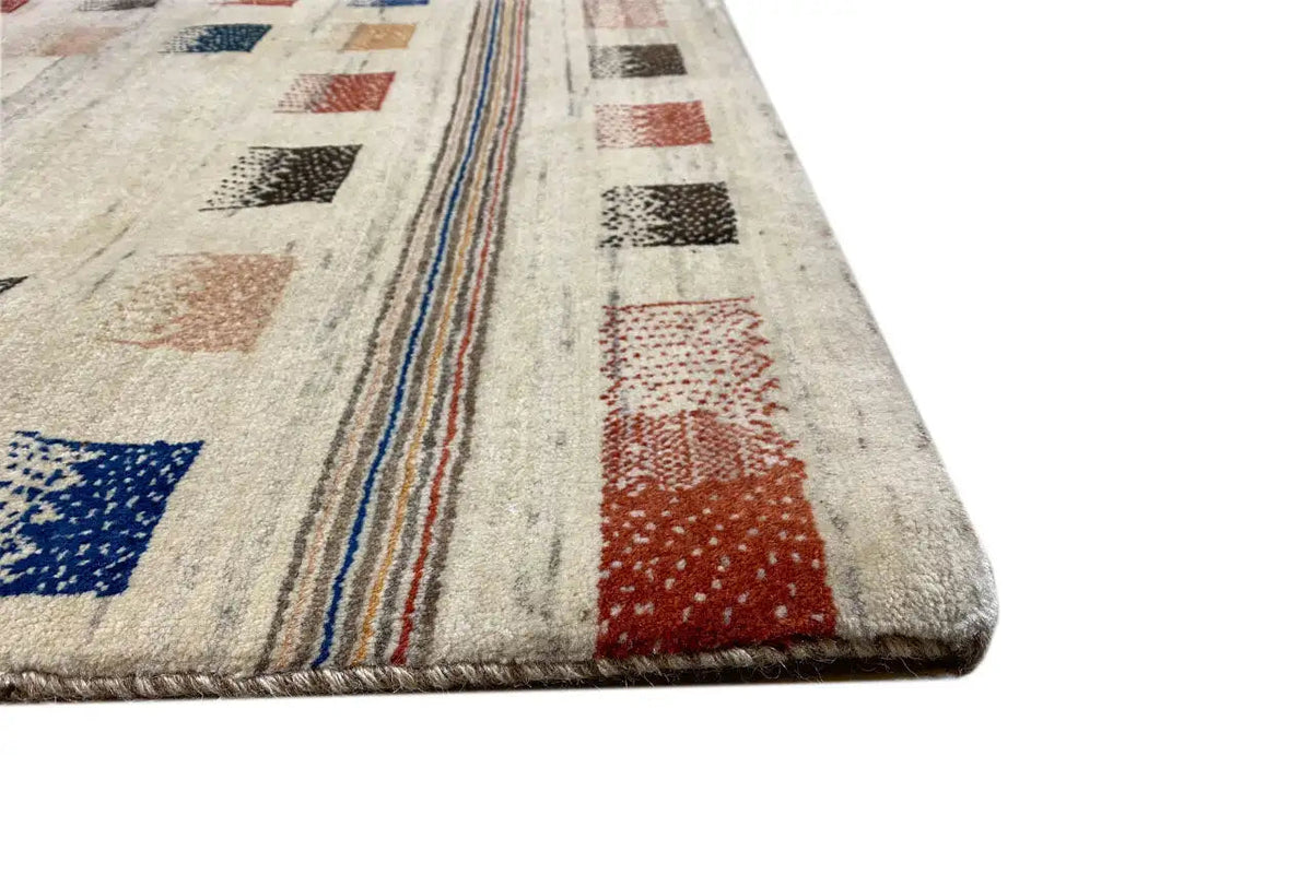 Gabbeh rug corner with beige pile, colorful stripes, and a densely woven border