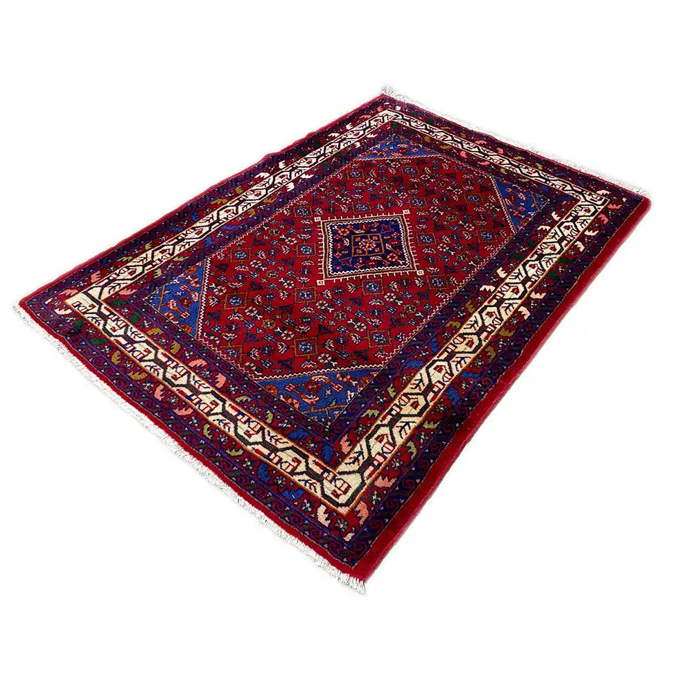 Rectangular oriental rug with a red background, blue border motif, and white/decorative borders