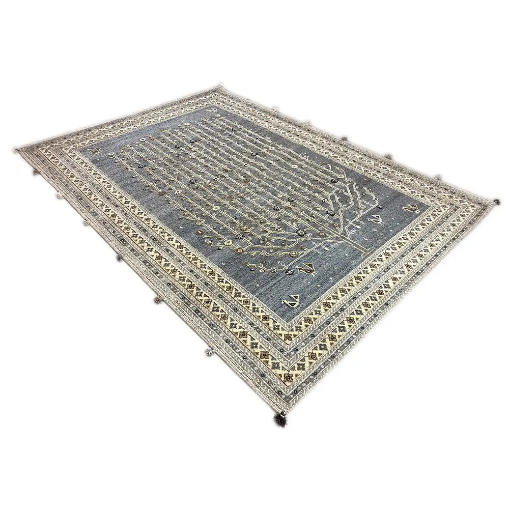 Rug with a blue-gray center and gold-colored border pattern, corners with tassels
