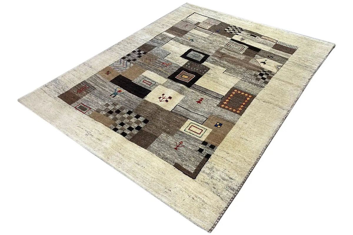 Rug at an angle: geometric patchwork in beige, gray, brown, and black