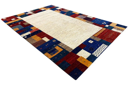 Gabbeh rug with a geometric patchwork border and a light central area