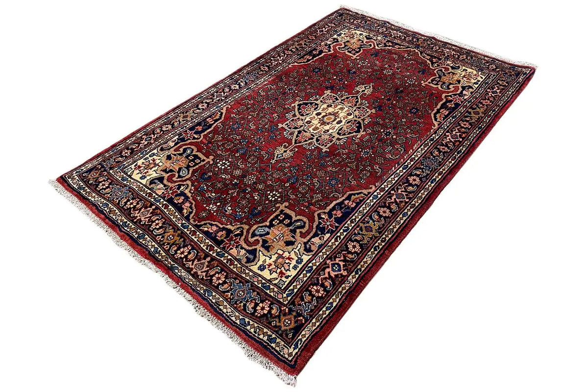 Dark red rug with fine border trim and a central pattern