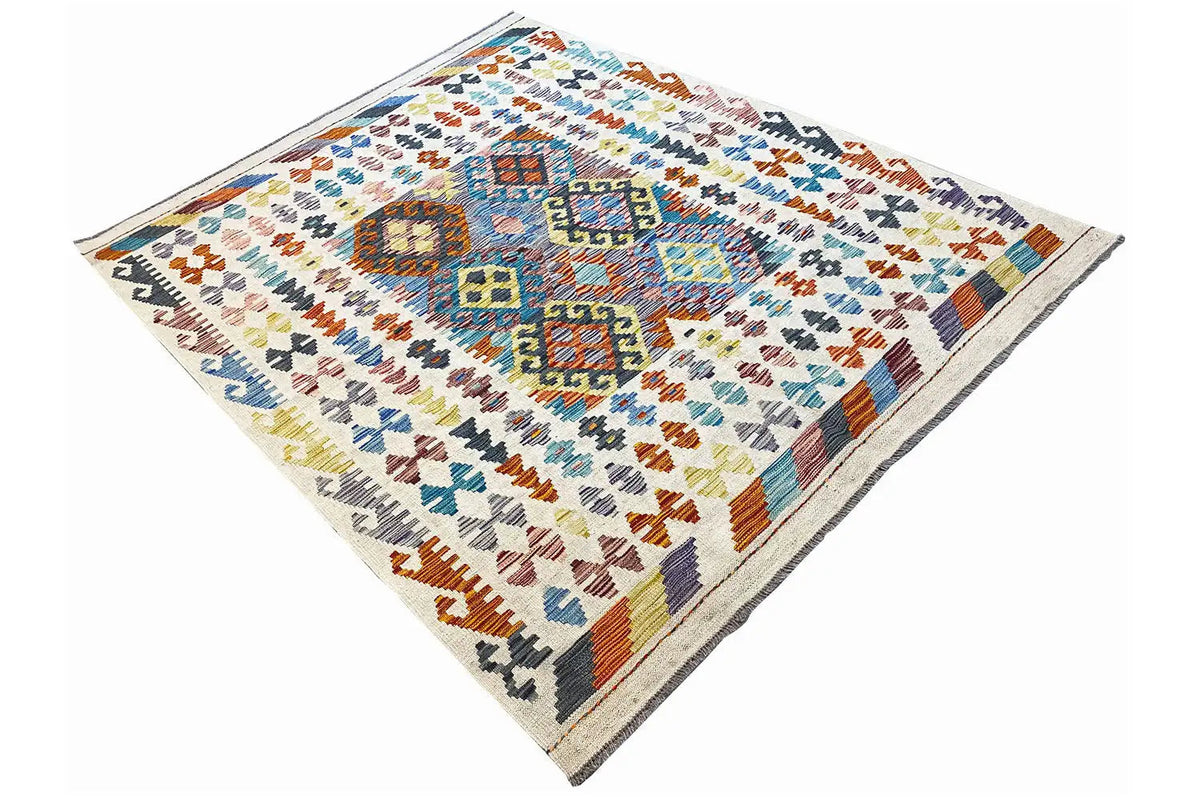 Afghan kilim rug, lying flat in a diagonal view with colorful patterns