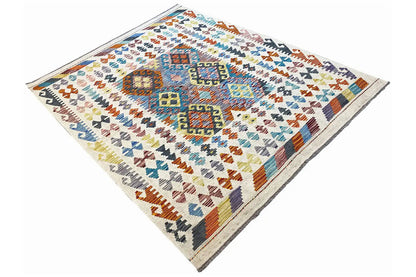 Afghan kilim rug, lying flat in a diagonal view with colorful patterns