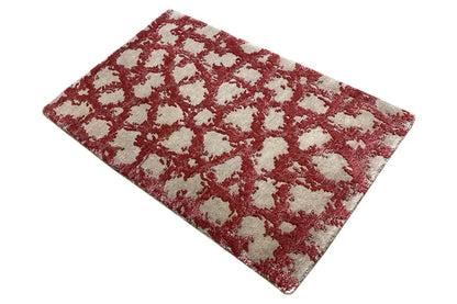 Rectangular rug with a red and cream-colored pattern