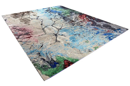 Designer rug with an abstract tree/vein motif in blue, gray, beige, red, and green.