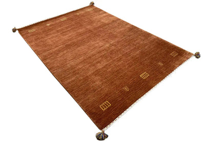 Brown Gabbeh woven rug spread out with square gold motifs and corner knots