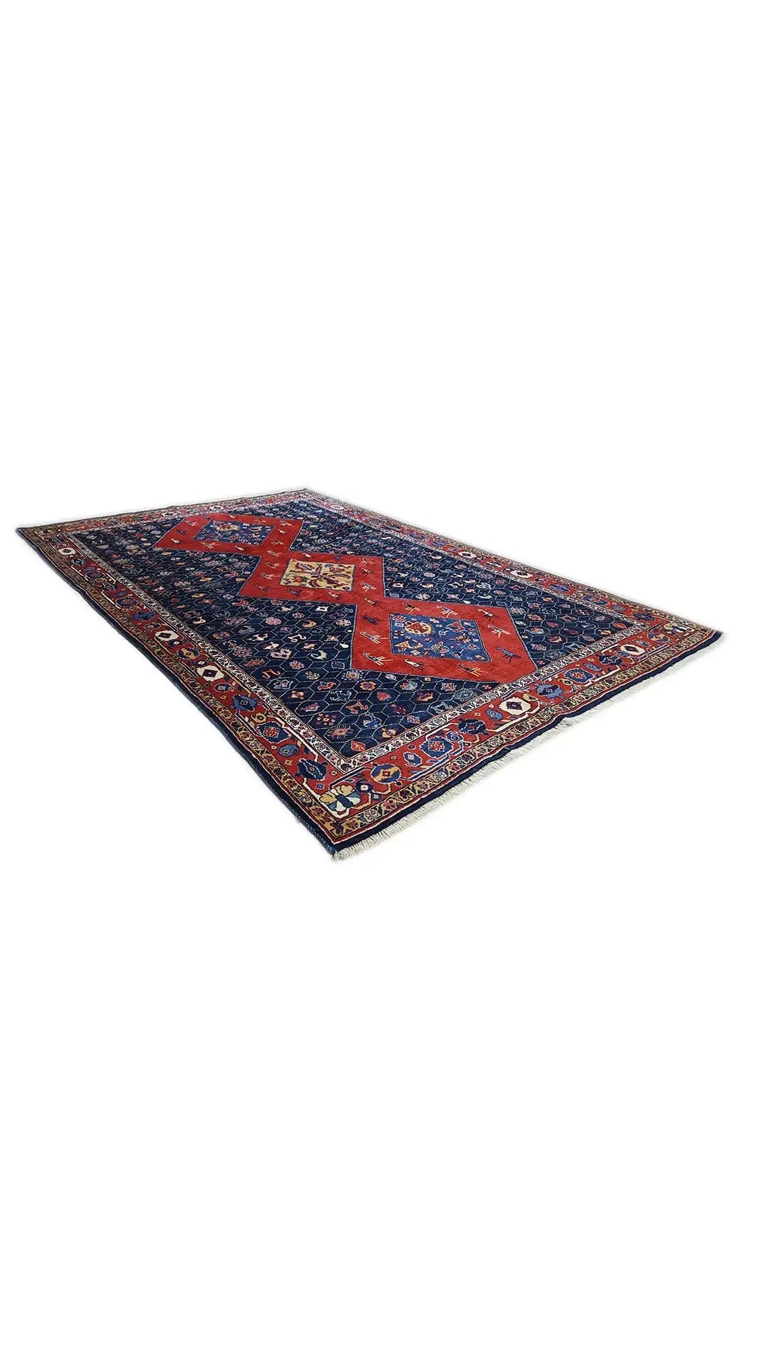 Blue-red oriental rug with a geometric medallion pattern, spread out