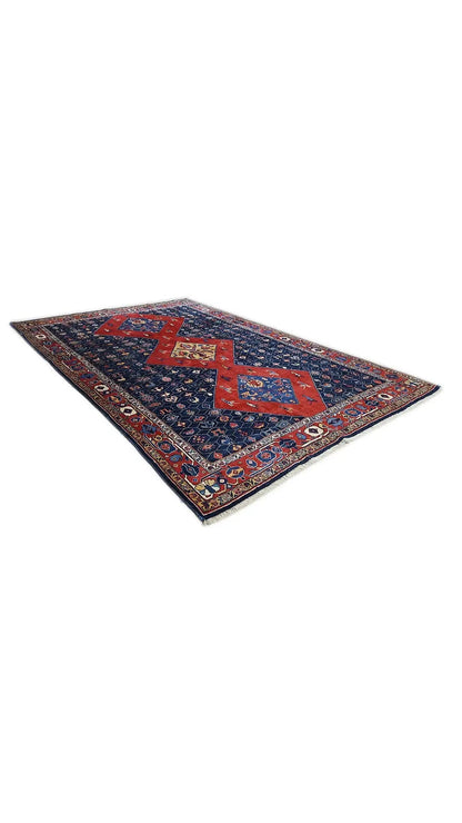 Blue-red oriental rug with a geometric medallion pattern, spread out