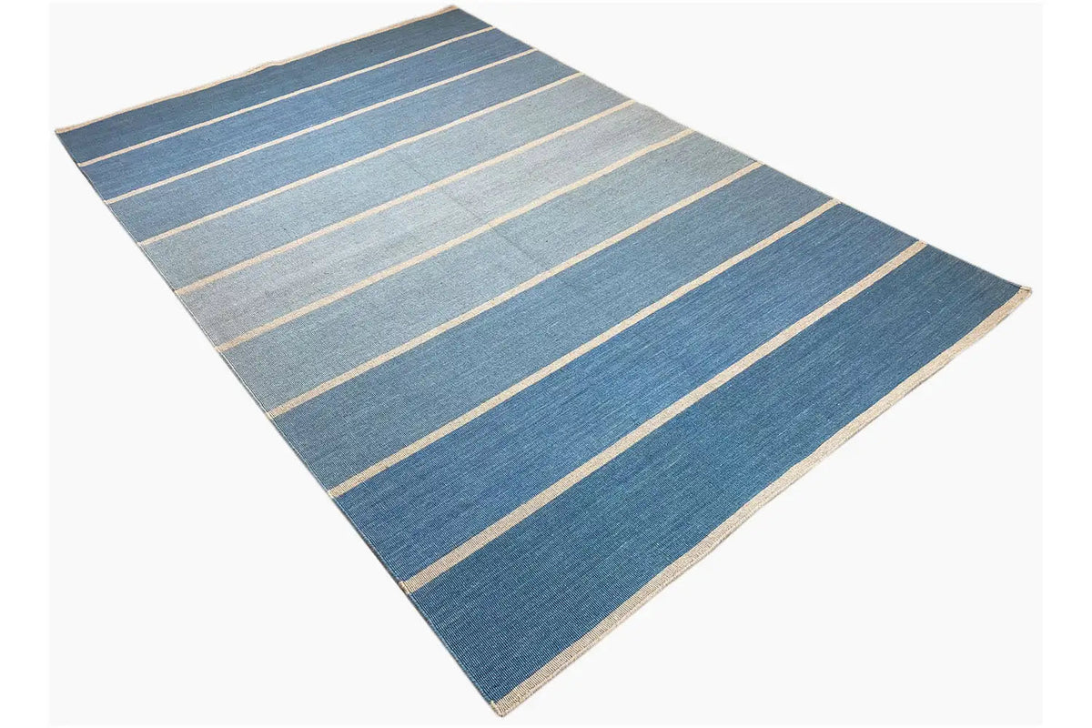 Kilim rug, shown diagonally: blue with beige stripes and narrow lines