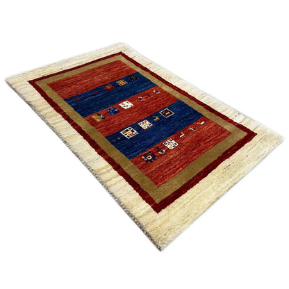 Cream Gabbeh rug with a red and blue field design and dark red border