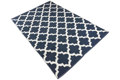 Kilim rug shown square/diagonally: white pattern on a dark blue background
