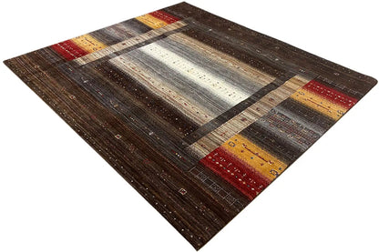 Brown Gabbeh rug with a diagonal stripe pattern, light central zones, and layers of color.