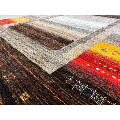Close-up of a Gabbeh rug: dense textures with striped fields in red, yellow, and brown