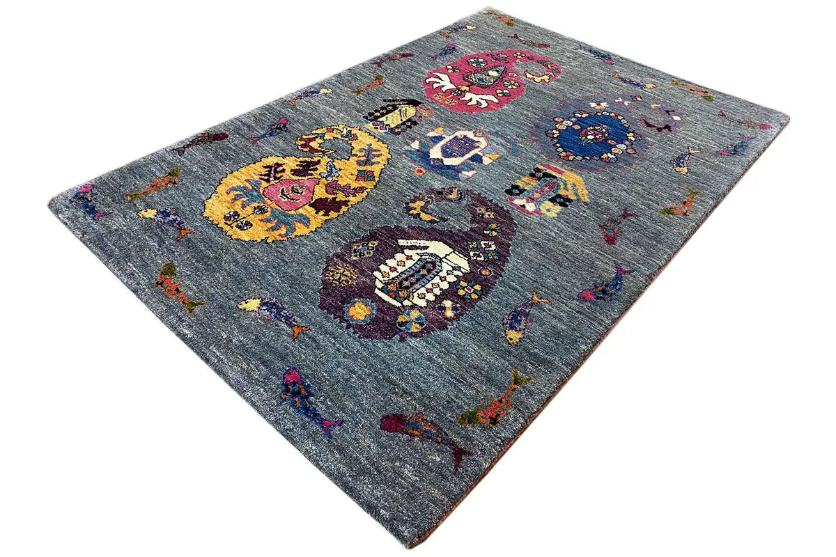 Gabbeh Lori rug in angled view, blue-gray with yellow and red ornaments