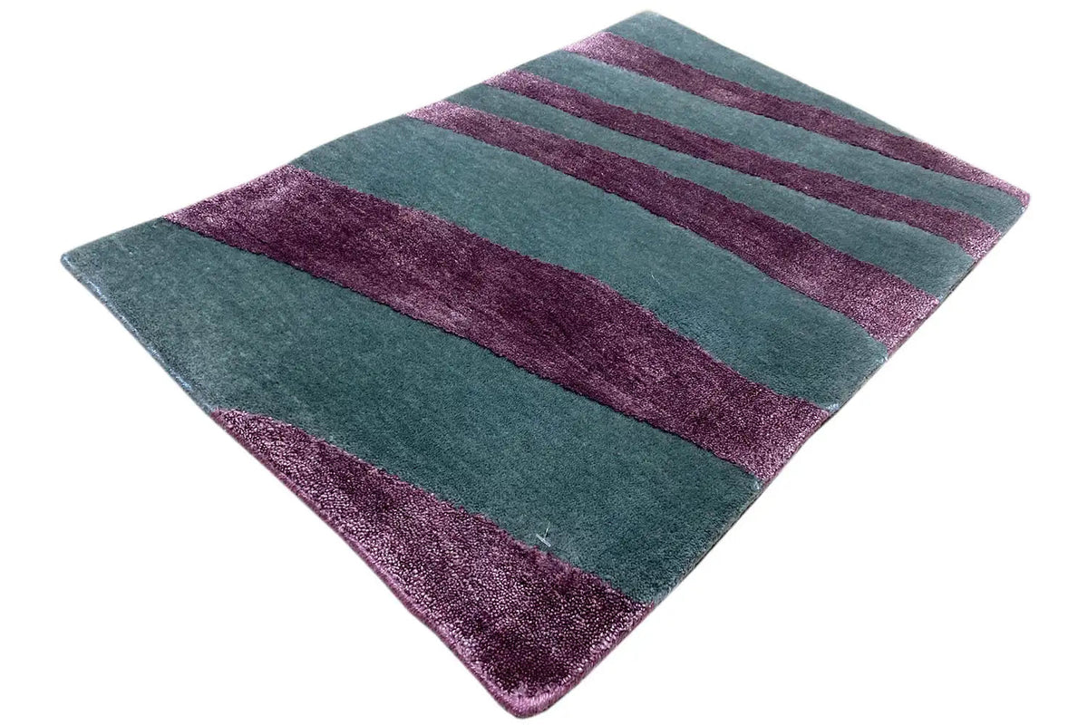 Rectangular rug with teal-green and purple stripes