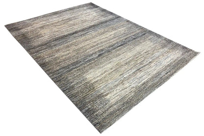 Gabbeh Lori rug draped diagonally; woven pattern in gray, beige, and dark gray