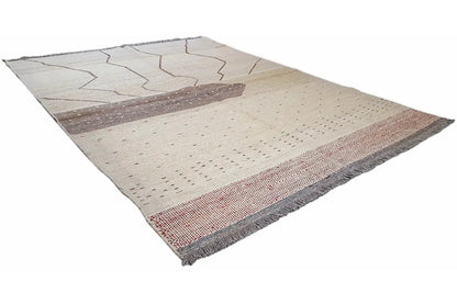 Kilim rug, seemingly triangular view, beige with a dark central zone and red accents along the edge
