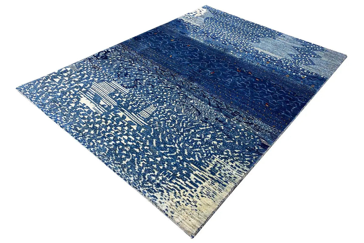 Gabbeh rug with a diamond pattern, blue gradient, and light ornament detail