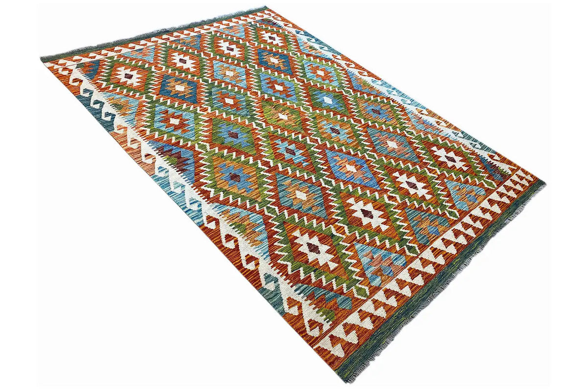 Rectangular kilim rug, diagonal view of geometric patterns and fringed edges