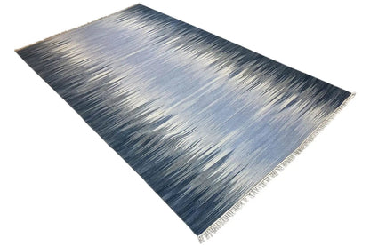 Kelim dhurrie rug with blue ombré pattern, diagonal view, with fringes