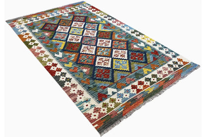 Kilim rug with a geometric pattern of squares, diamonds, and a decorative border