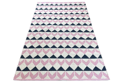 Kilim rug draped into a triangle, striped pattern in pink, white, and dark blue