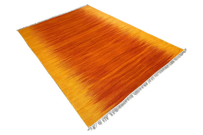 Yellow-orange kilim rug with fringes, diagonal view of the weave structure