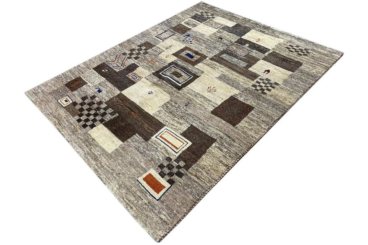 Gabbeh rug with a geometric pattern in gray/beige, dark squares and small color details